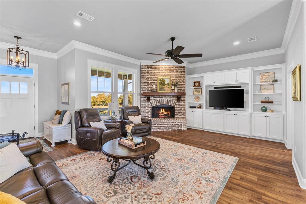1694 Henry Prairie Road Franklin, TX 77856 - Photo 12 of 40 a living room with furniture a flat screen tv and a fireplace