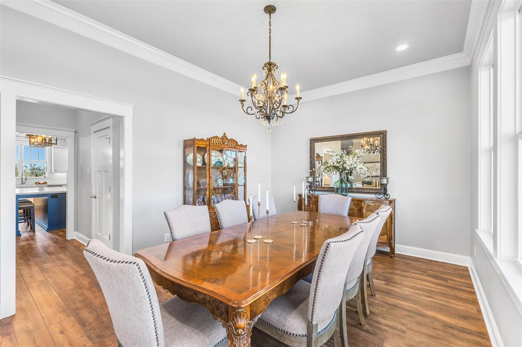 1694 Henry Prairie Road Franklin, TX 77856 - Photo 17 of 40 a dining room with furniture a chandelier and wooden floor