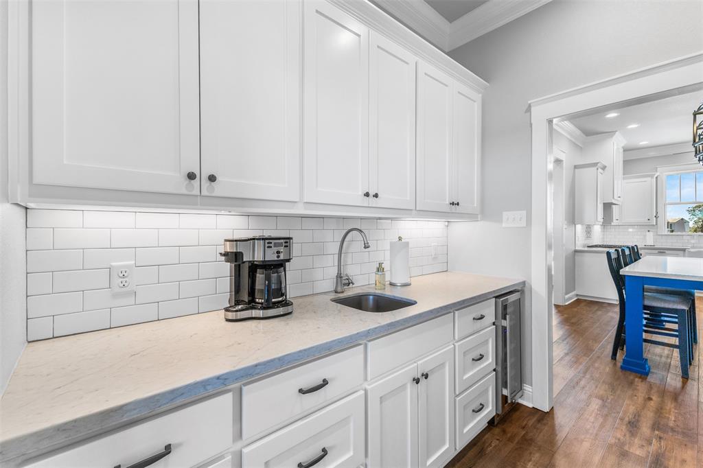 1694 Henry Prairie Road Franklin, TX 77856 - Photo 19 of 40 a kitchen with white cabinets and sink