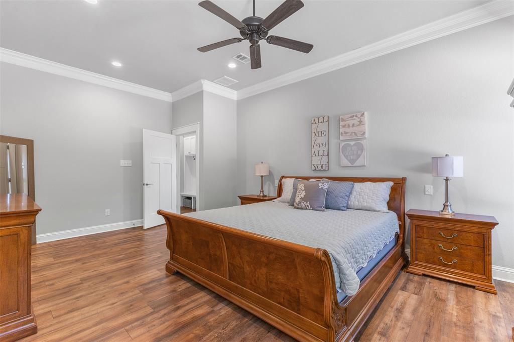 1694 Henry Prairie Road Franklin, TX 77856 - Photo 25 of 40 a bedroom with a bed and wooden floor