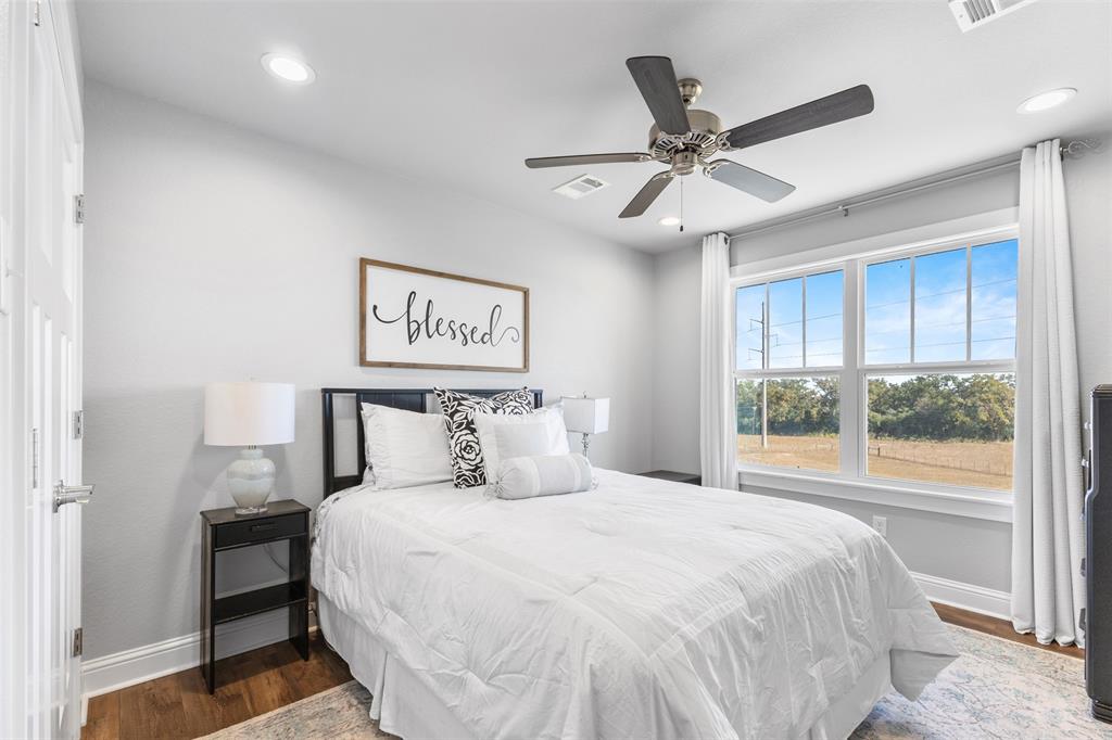 1694 Henry Prairie Road Franklin, TX 77856 - Photo 30 of 40 a bedroom with a large bed and a large window