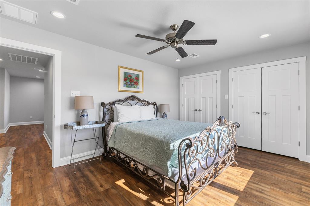 1694 Henry Prairie Road Franklin, TX 77856 - Photo 31 of 40 a bedroom with a bed and a chandelier