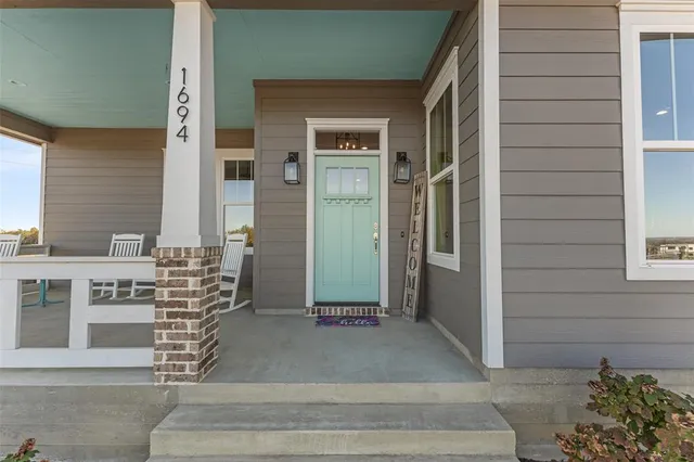 a view of a dining room with furniture a chandelier and wooden floor