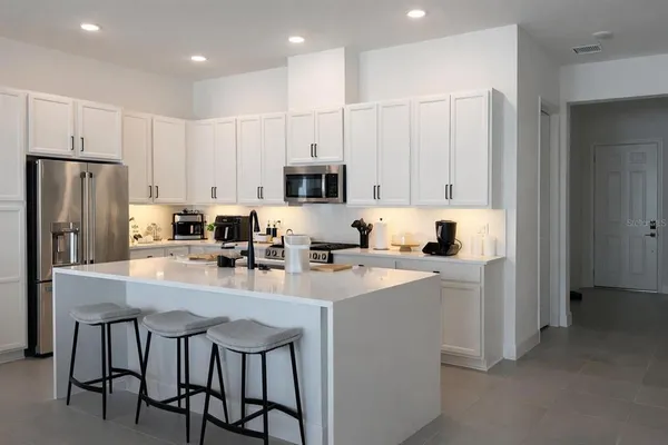 a kitchen with kitchen island a appliances and cabinets