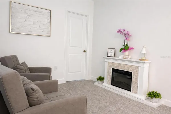 a living room with furniture and a chandelier