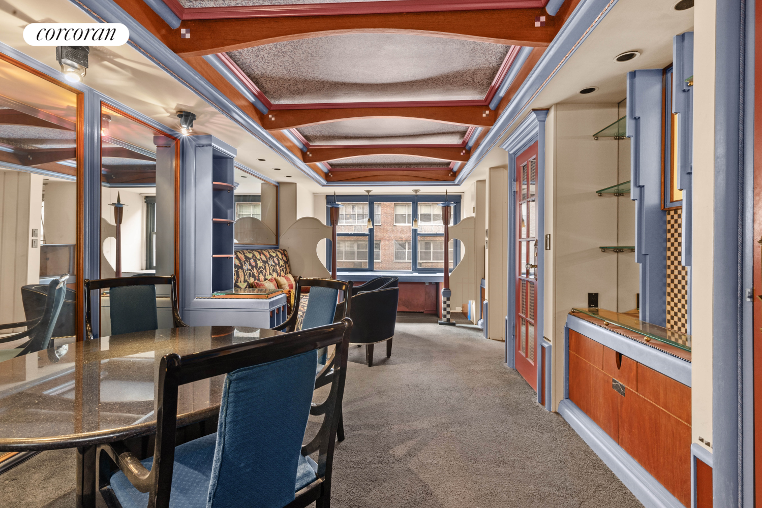 a dining room with furniture a chandelier and a rug