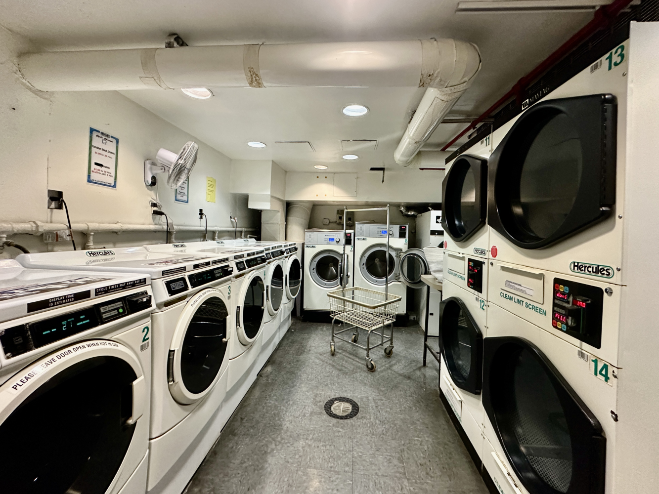 220 East 57th Street, Unit 4C Manhattan, NY 10022 - Photo 12 of 12 a utility room with dryer washer and a view of living room