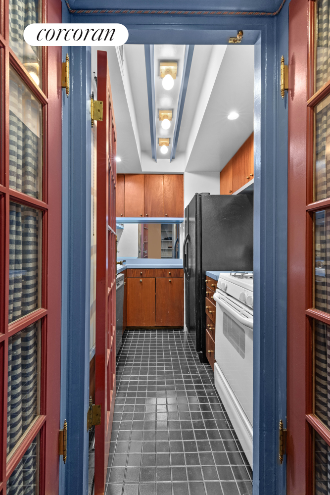 220 East 57th Street, Unit 4C Manhattan, NY 10022 - Photo 3 of 12 a kitchen with a refrigerator and wooden floor