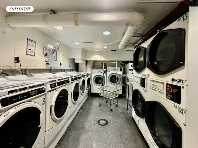 a utility room with dryer washer and a view of living room