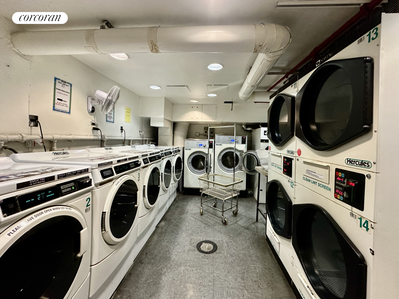 220 East 57th Street, Unit 4C Manhattan, NY 10022 - Photo 6 of 12 a utility room with dryer washer and a view of living room