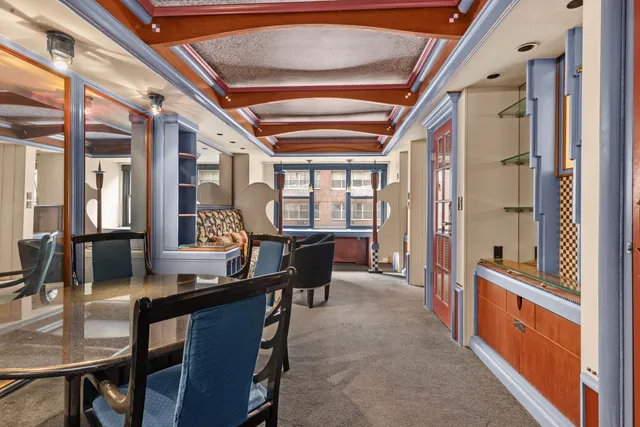 a dining room with furniture a chandelier and a rug
