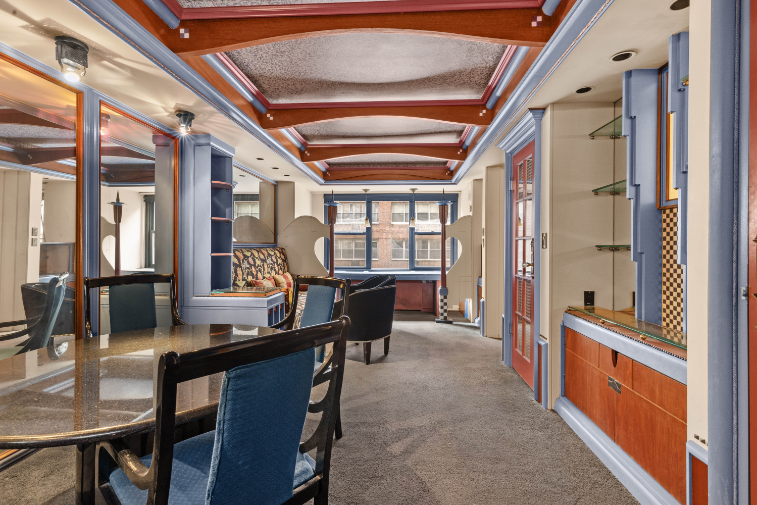 220 East 57th Street, Unit 4C Manhattan, NY 10022 - Photo 7 of 12 a dining room with furniture a chandelier and a rug