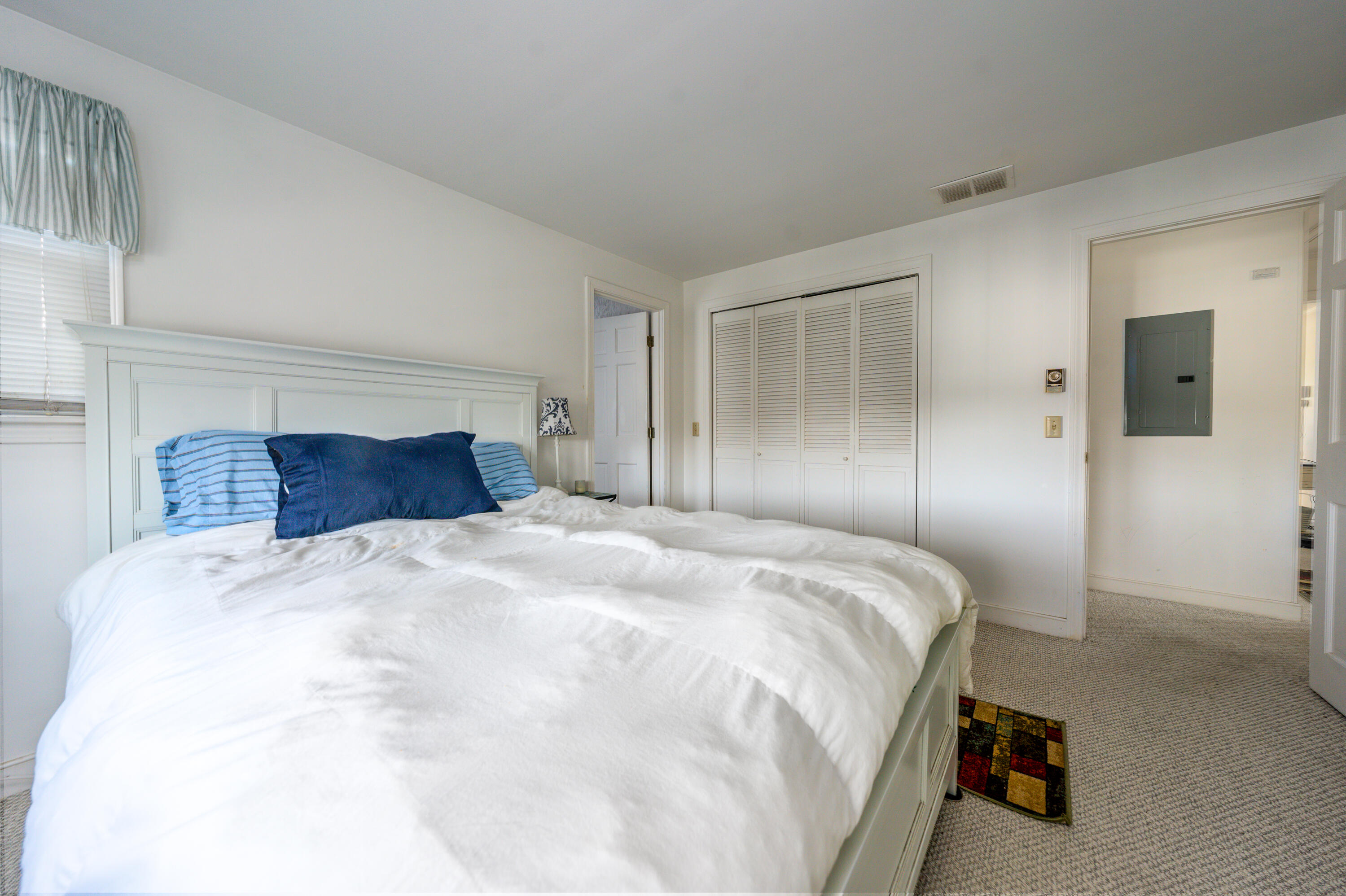 36 Belmont Road, Unit USW21 West Harwich, MA 02671 - Photo 15 of 20 a bedroom with a bed and a large mirror