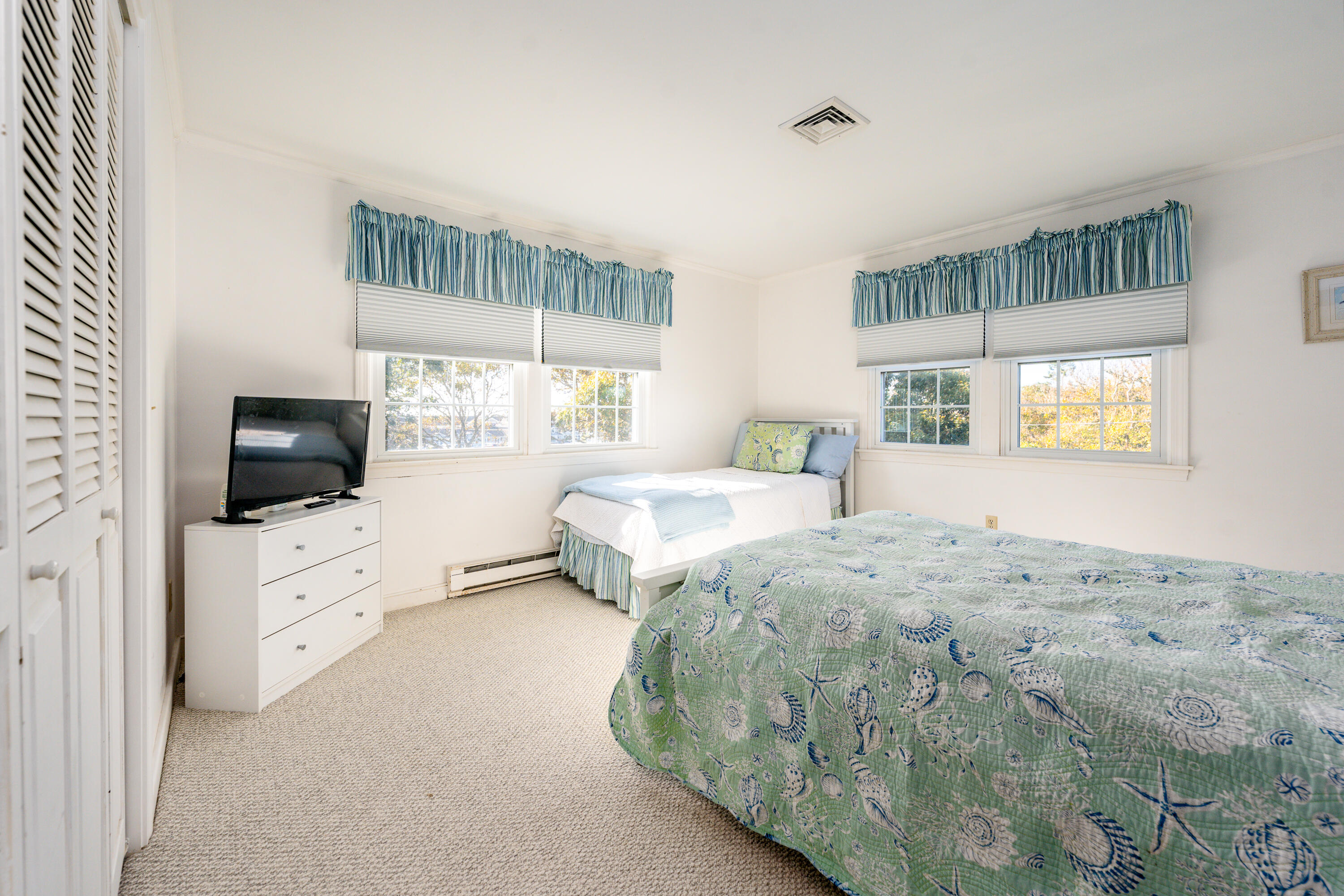 36 Belmont Road, Unit USW21 West Harwich, MA 02671 - Photo 16 of 20 a spacious bedroom with a bed and a flat screen tv
