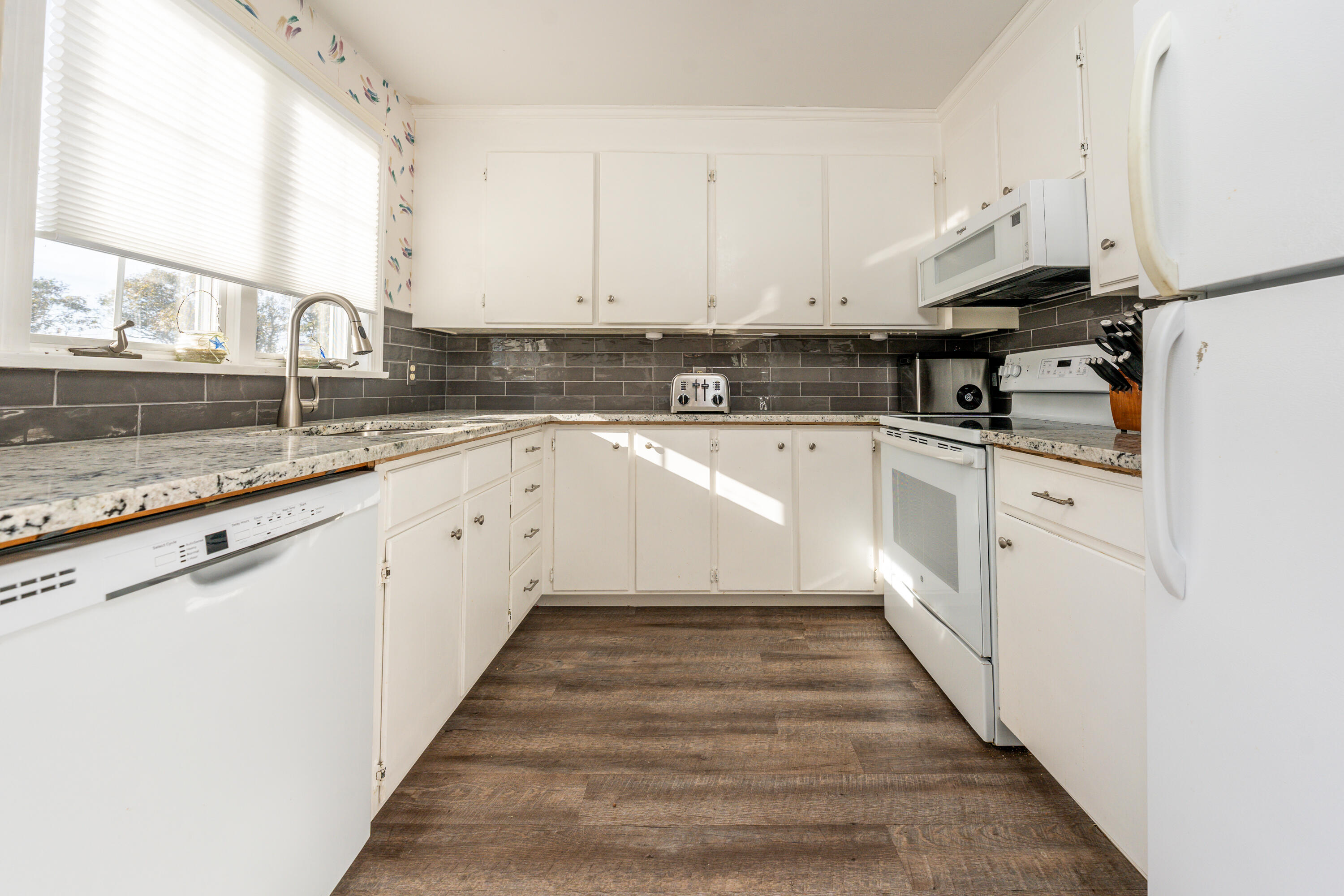 36 Belmont Road, Unit USW21 West Harwich, MA 02671 - Photo 7 of 20 a kitchen with granite countertop white cabinets and white appliances