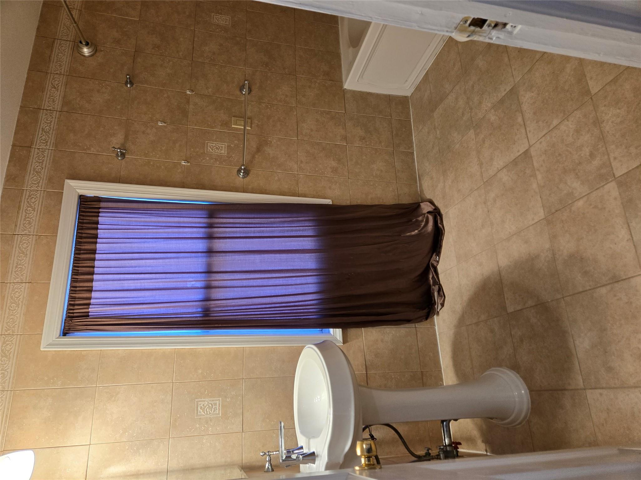 189-07 Quencer Road Queens, NY 11412 - Photo 13 of 36 a bathroom with a sink and a toilet