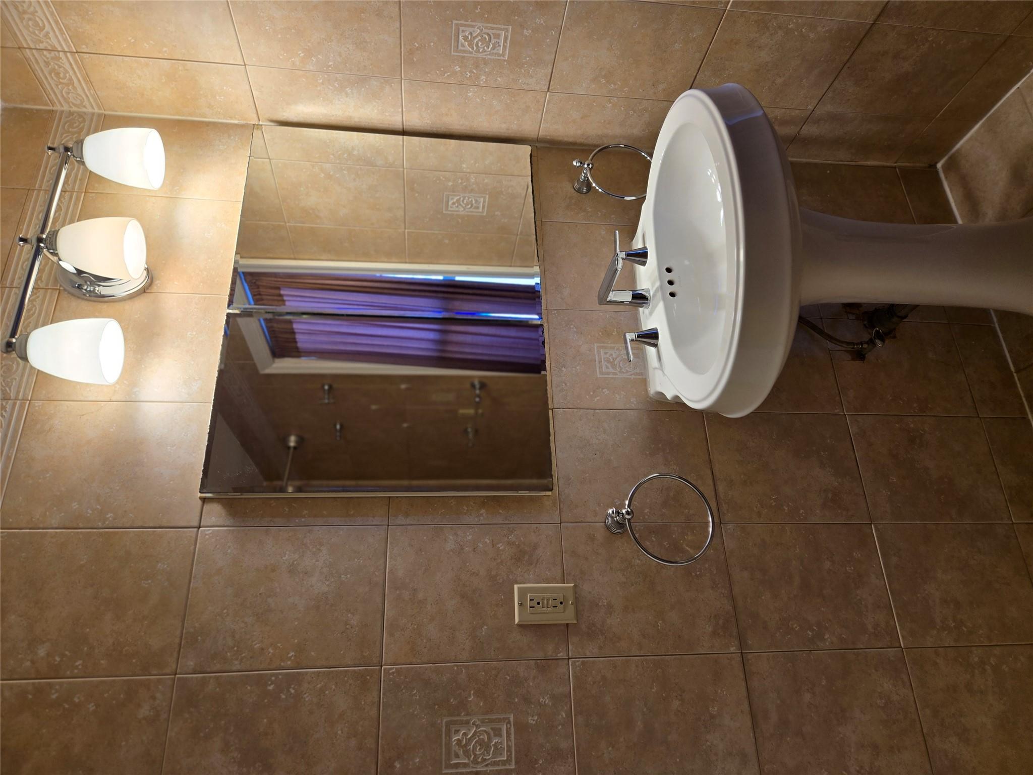 189-07 Quencer Road Queens, NY 11412 - Photo 15 of 36 a bathroom with a sink and a mirror