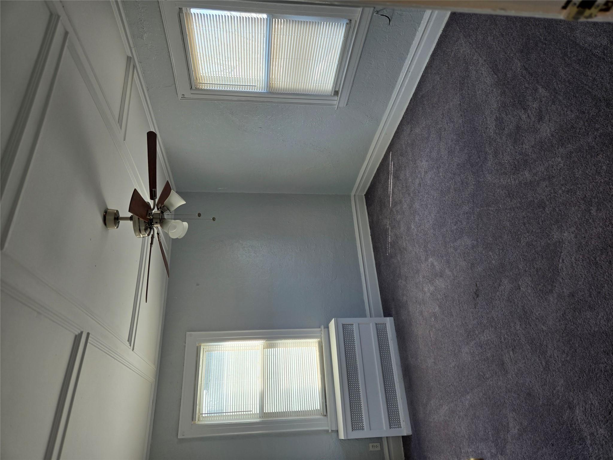 189-07 Quencer Road Queens, NY 11412 - Photo 20 of 36 an empty room with windows and fan