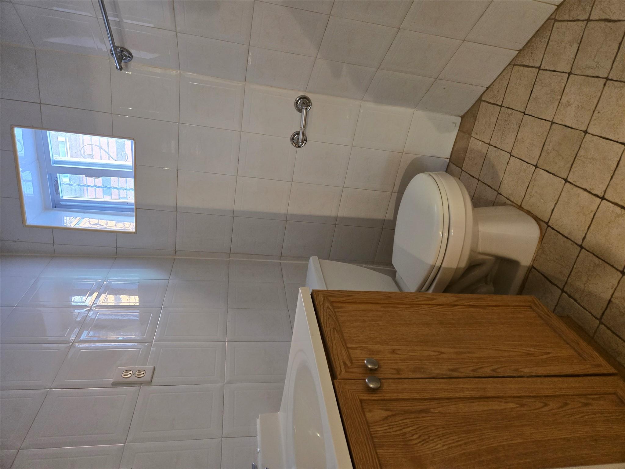 189-07 Quencer Road Queens, NY 11412 - Photo 29 of 36 a bathroom with a toilet and a shower