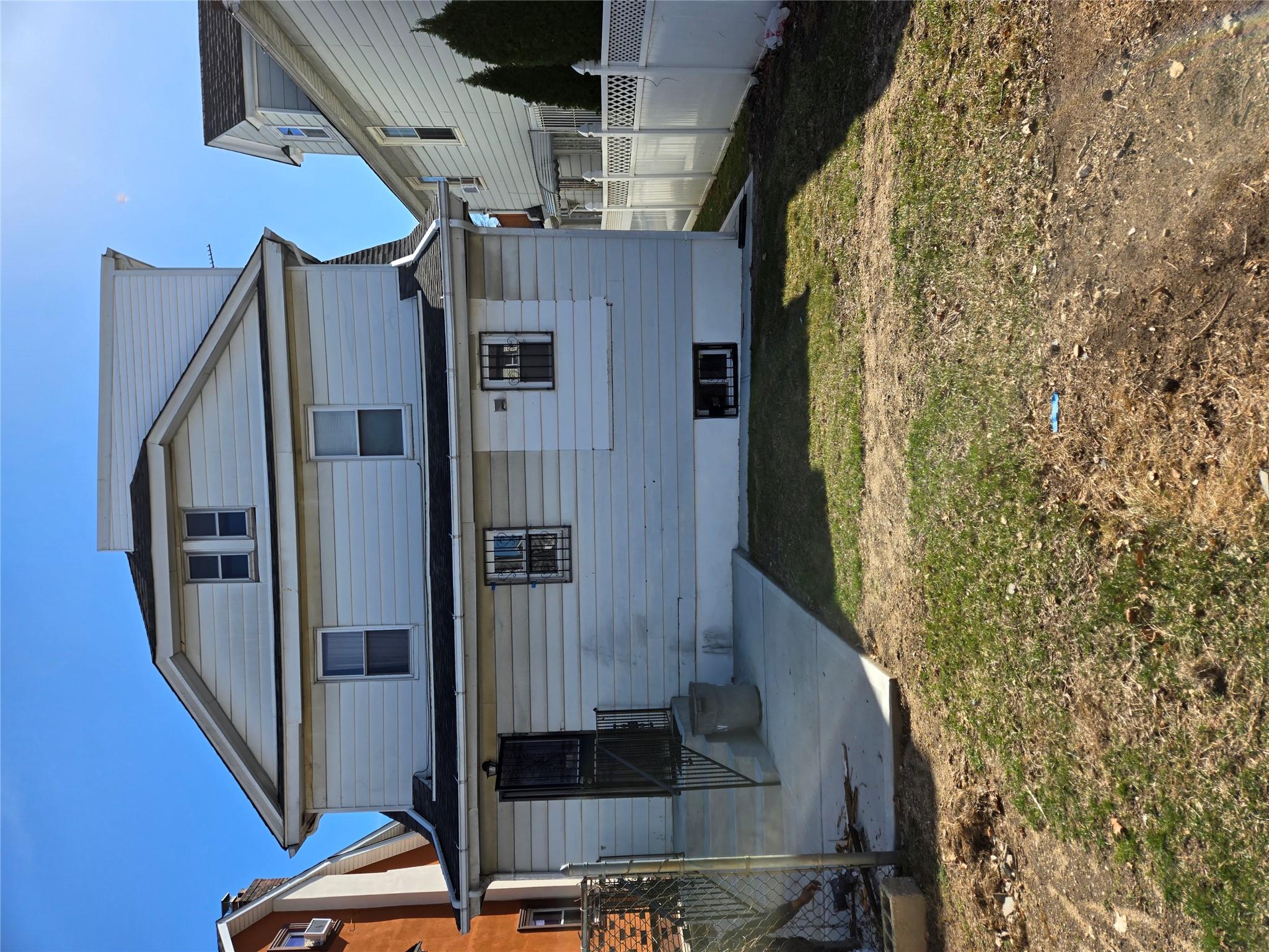 189-07 Quencer Road Queens, NY 11412 - Photo 3 of 36 a front view of a house with a yard