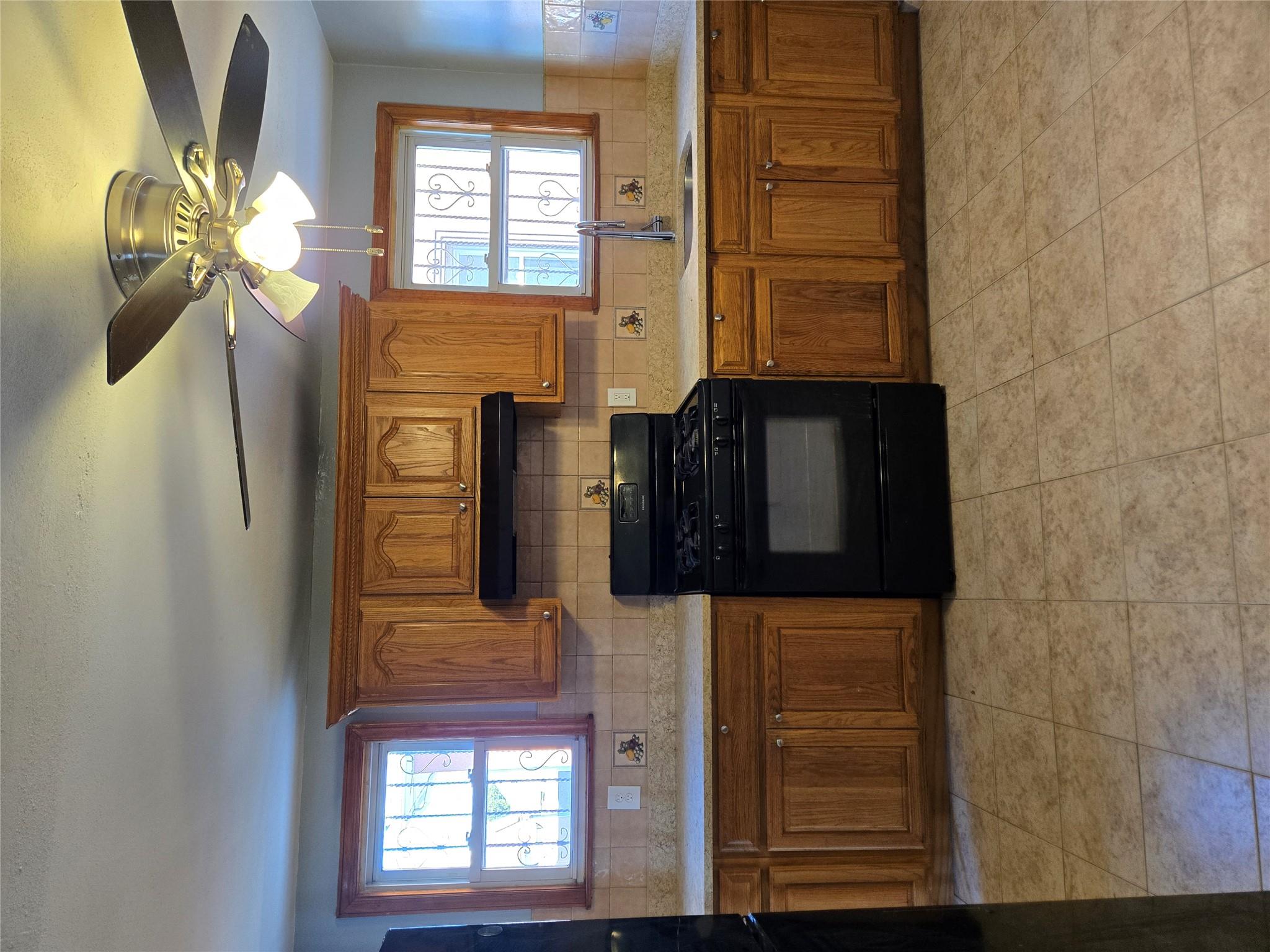 189-07 Quencer Road Queens, NY 11412 - Photo 10 of 36 a kitchen with a stove sink and microwave