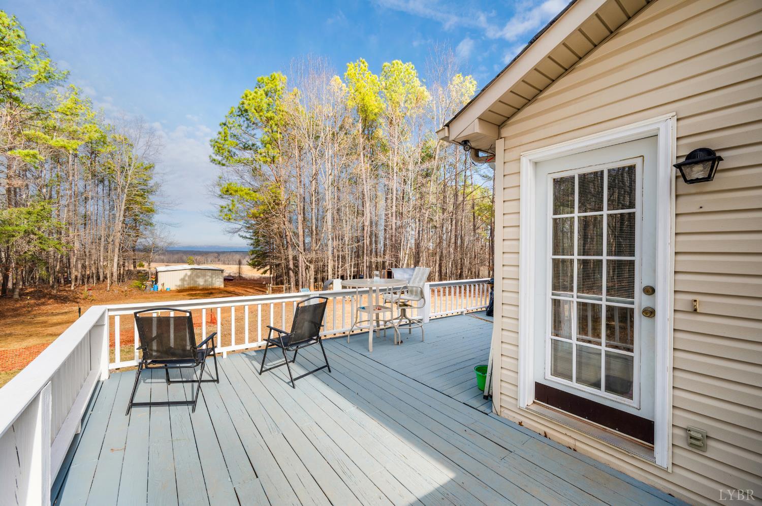 3105 Horseshoe Road Appomattox, VA 24522 - Photo 33 of 59 a view of a balcony with chairs and wooden floor