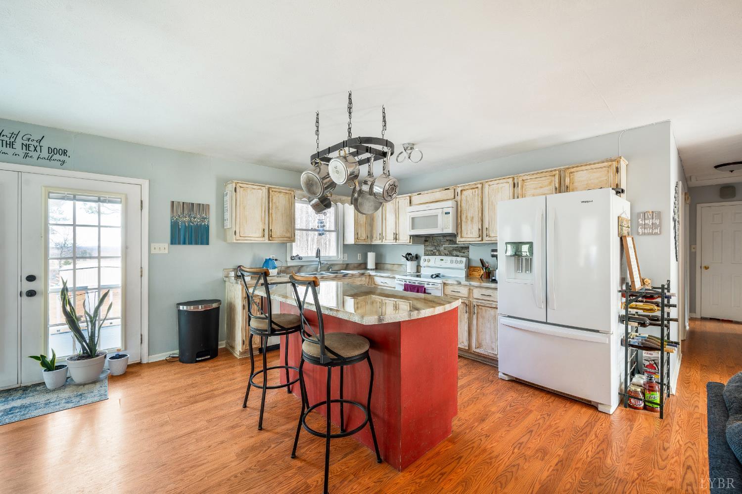 3105 Horseshoe Road Appomattox, VA 24522 - Photo 8 of 59 a kitchen with stainless steel appliances granite countertop a refrigerator a stove a sink dishwasher a dining table and chairs with wooden floor