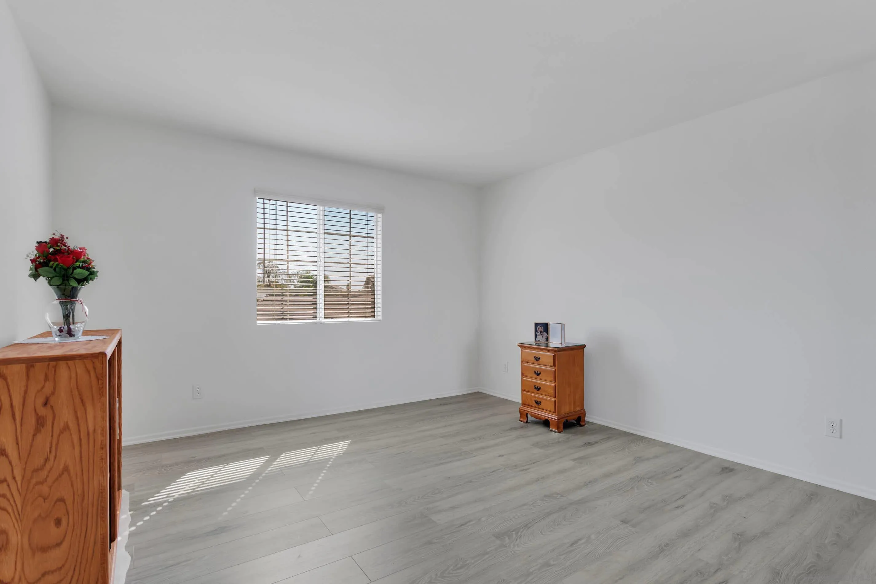 3080 Nightwind Circle Corona, CA 92882 - Photo 25 of 62 an empty room with wooden floor and windows