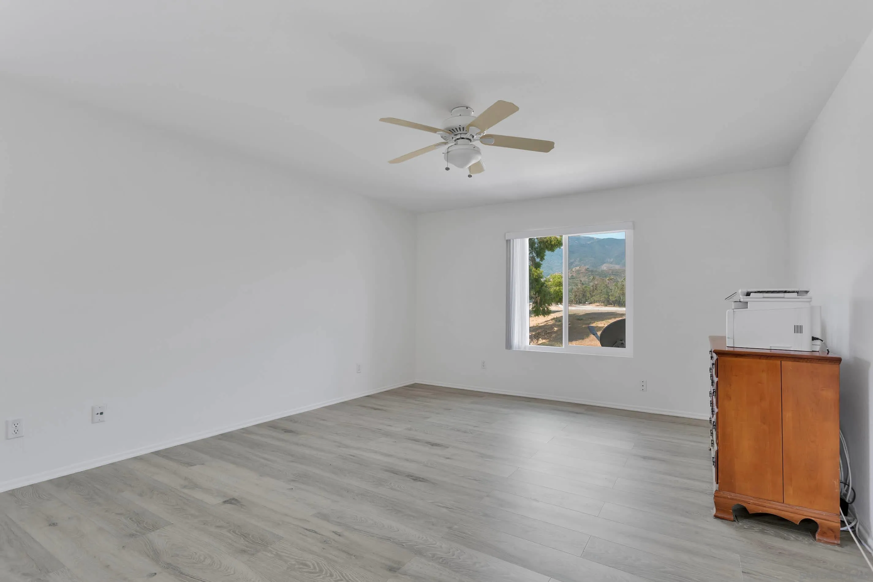 3080 Nightwind Circle Corona, CA 92882 - Photo 27 of 62 a view of an empty room with a window and wooden floor