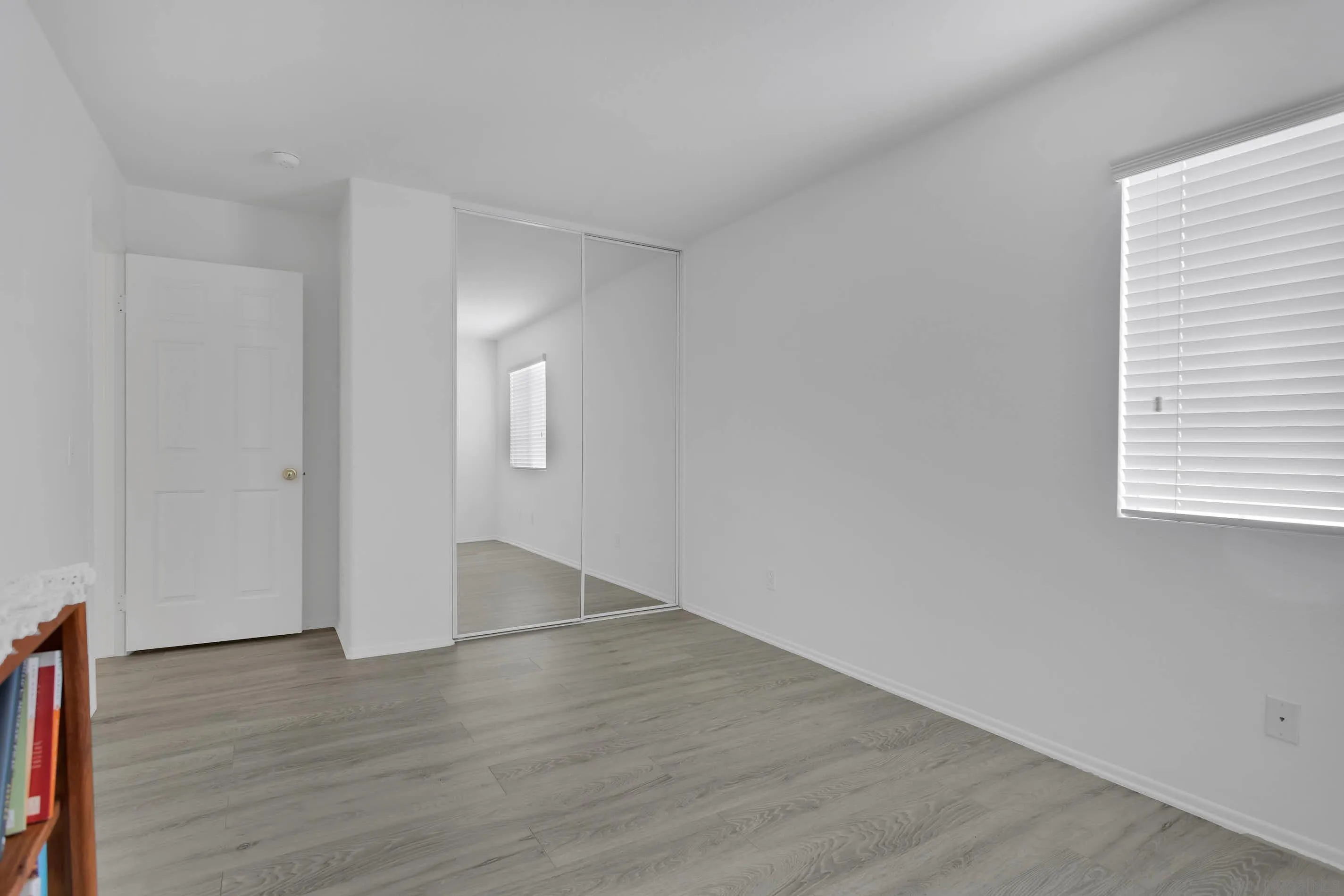 3080 Nightwind Circle Corona, CA 92882 - Photo 36 of 62 an empty room with wooden floor and windows