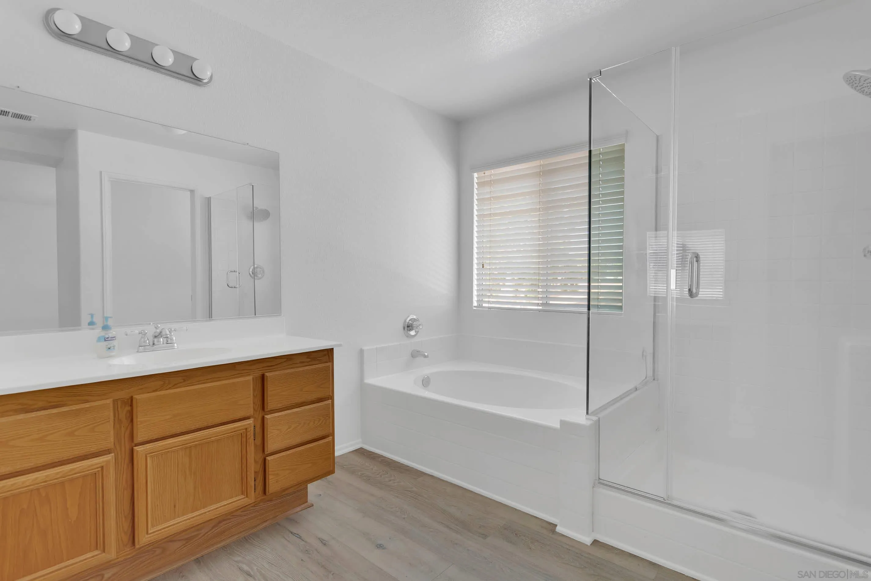 3080 Nightwind Circle Corona, CA 92882 - Photo 38 of 62 a bathroom with a tub sink and mirror