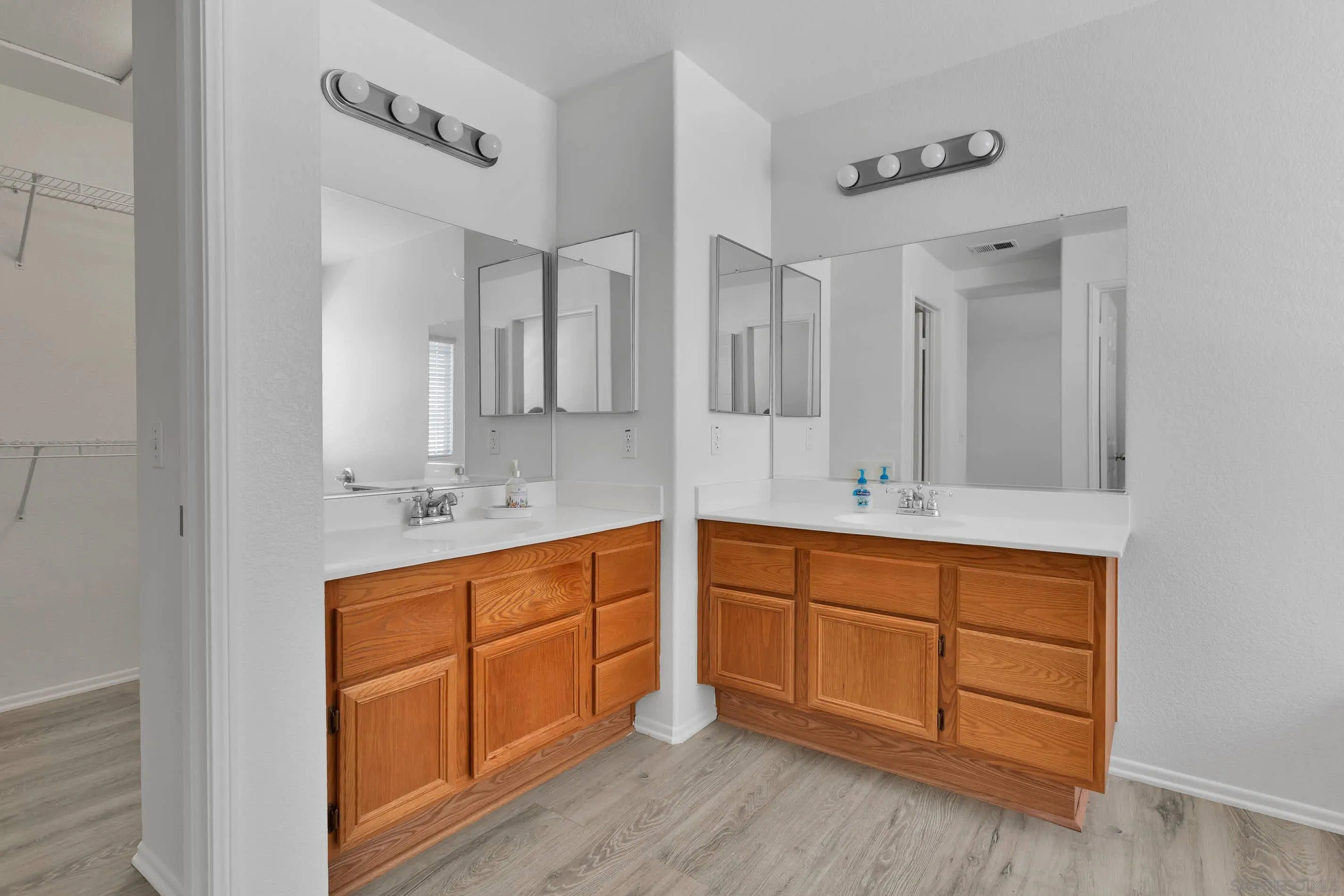 3080 Nightwind Circle Corona, CA 92882 - Photo 39 of 62 a spacious bathroom with double vanity and mirrors