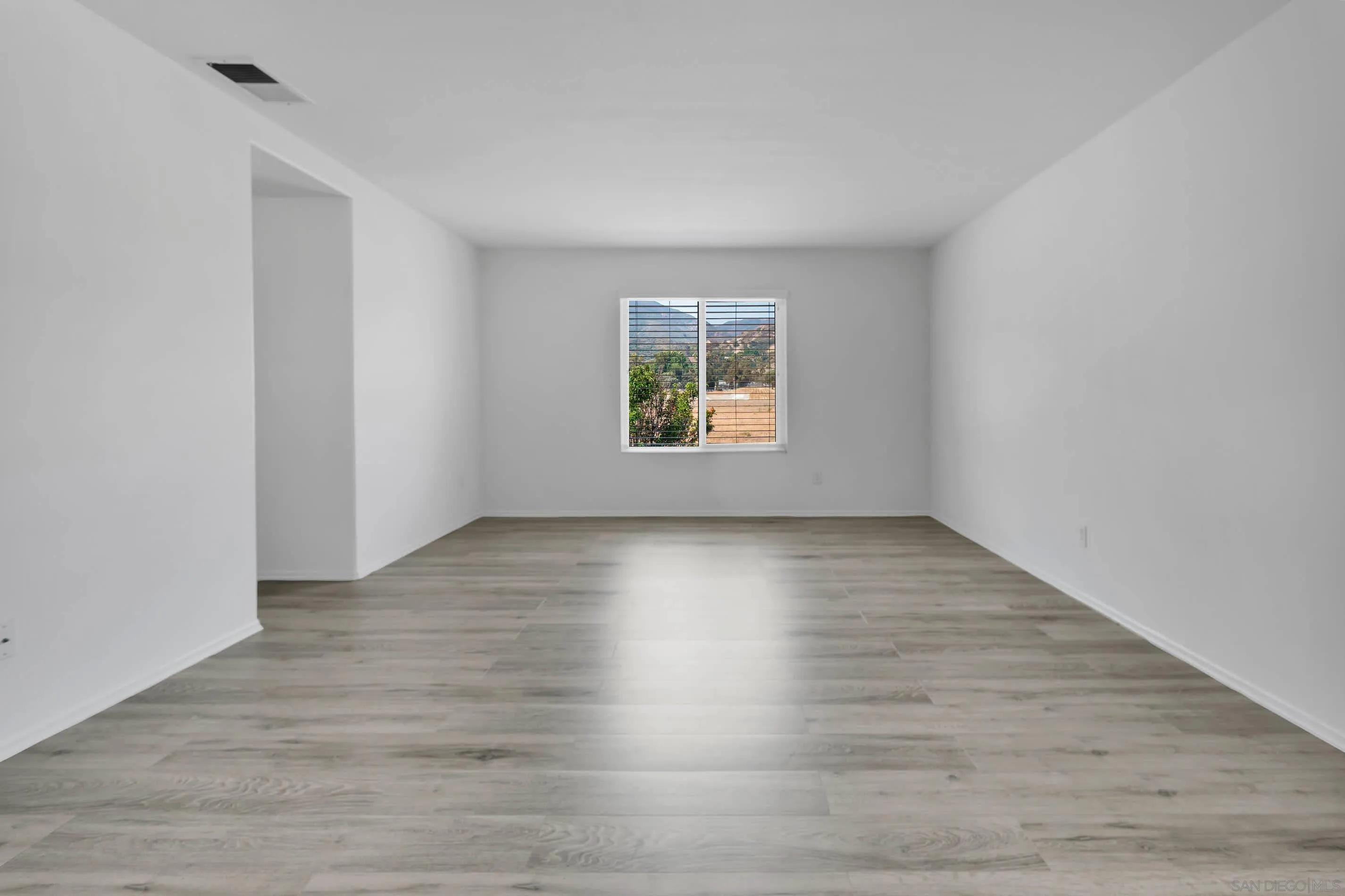 3080 Nightwind Circle Corona, CA 92882 - Photo 40 of 62 an empty room with wooden floor and window