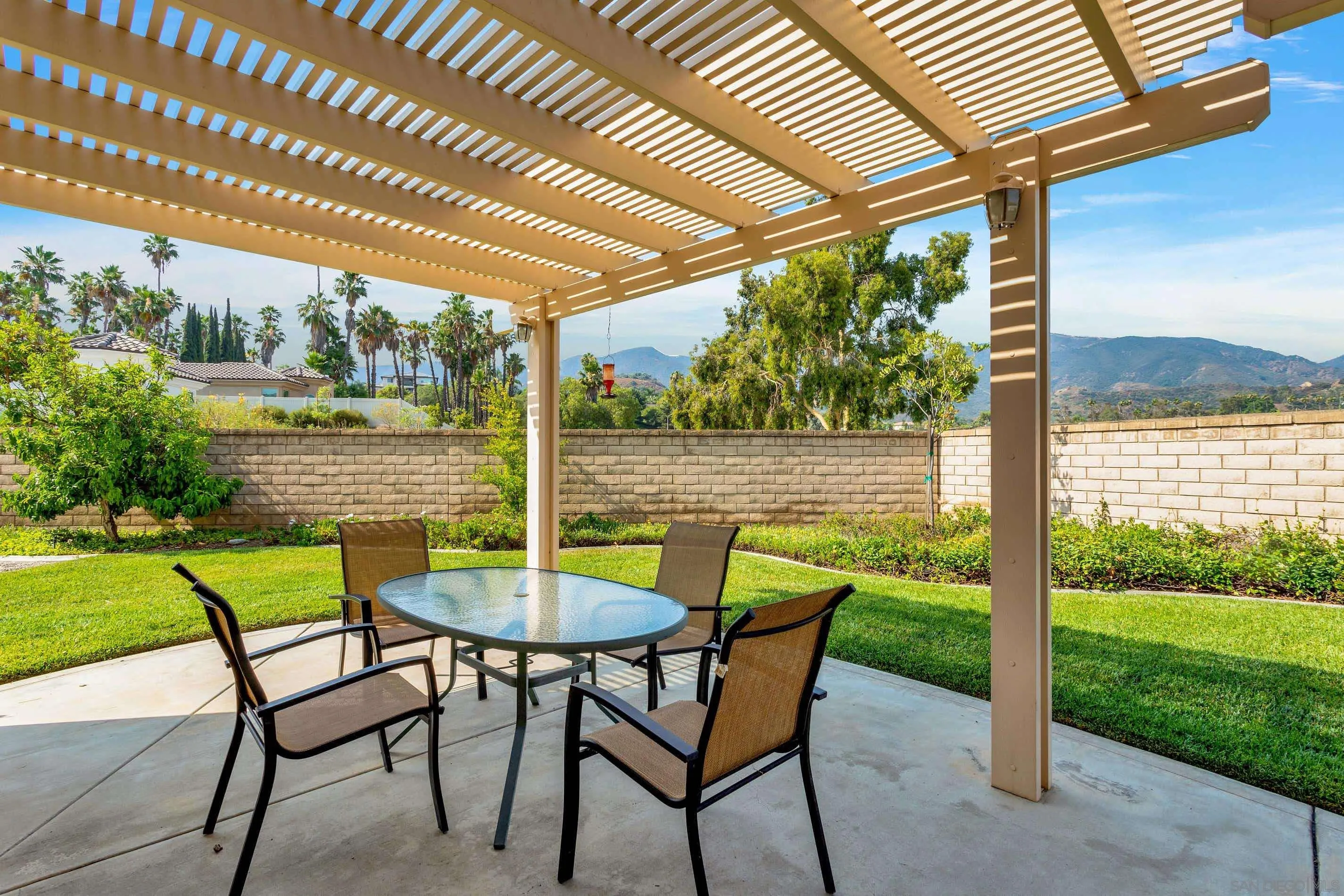 3080 Nightwind Circle Corona, CA 92882 - Photo 43 of 62 a view of a chairs and table in the patio next to a yard