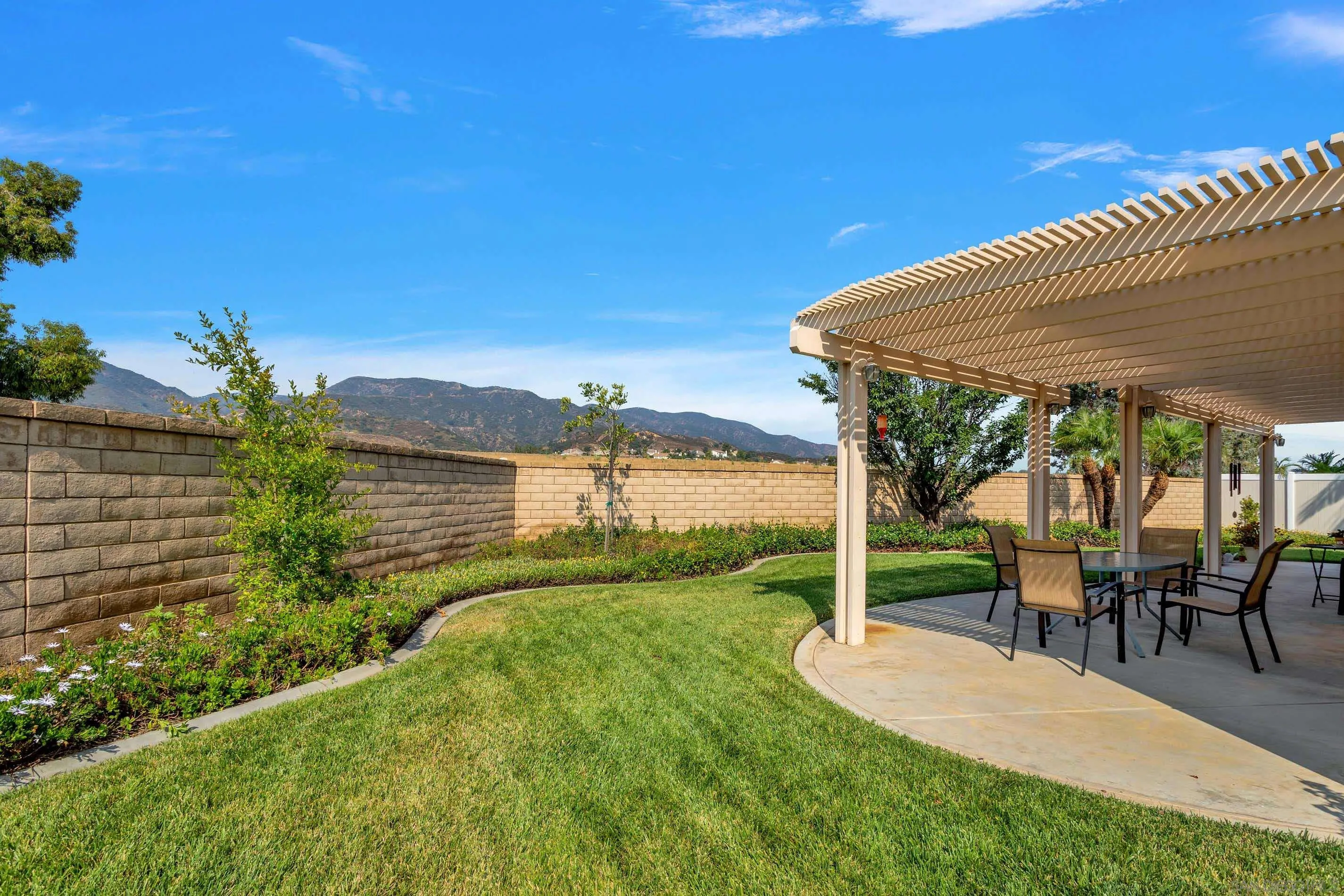3080 Nightwind Circle Corona, CA 92882 - Photo 47 of 62 a view of a patio with table and chairs under an umbrella