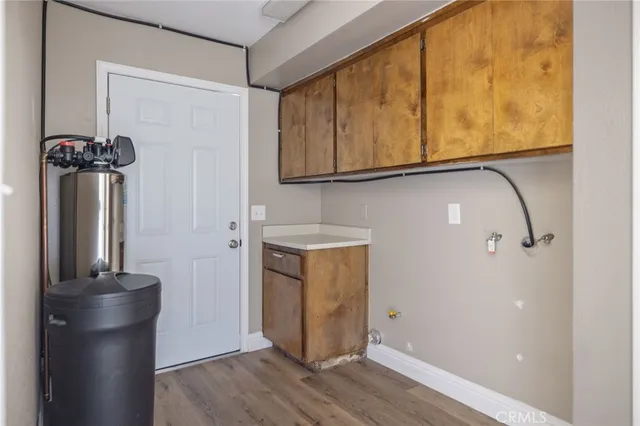 a view of a hallway with wooden floor and closet