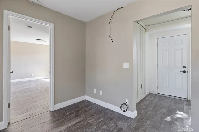 a view of a room with wooden floor