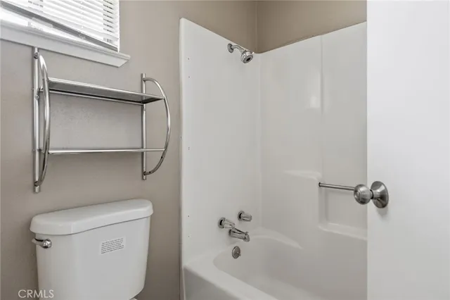 a white bath tub sitting next to a toilet