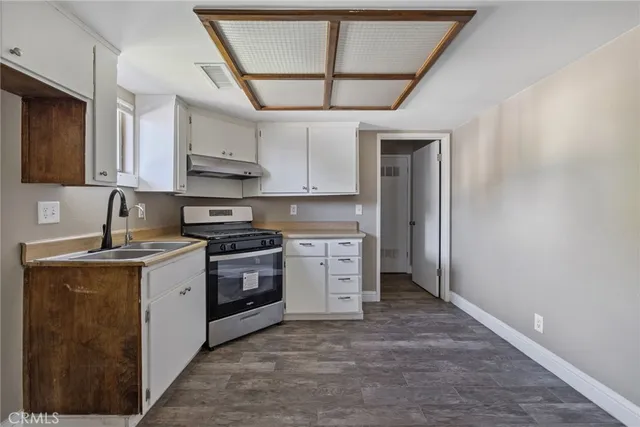 a kitchen with stainless steel appliances granite countertop a stove and a refrigerator
