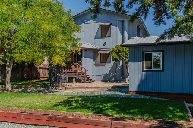 a large kitchen with stainless steel appliances granite countertop a stove and a sink