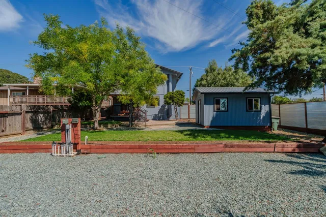 a kitchen with stainless steel appliances a sink a stove a refrigerator cabinets and a window