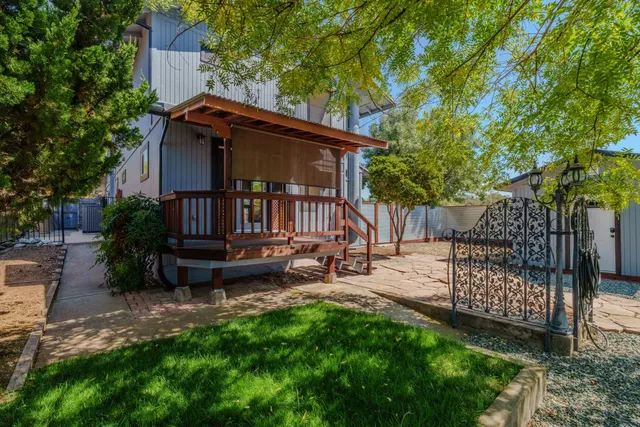 a kitchen with granite countertop a sink cabinets and wooden floor