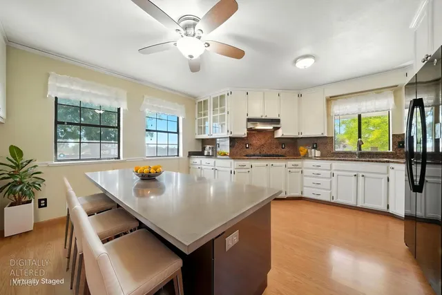 a spacious bedroom with a bed a couch and a chandelier