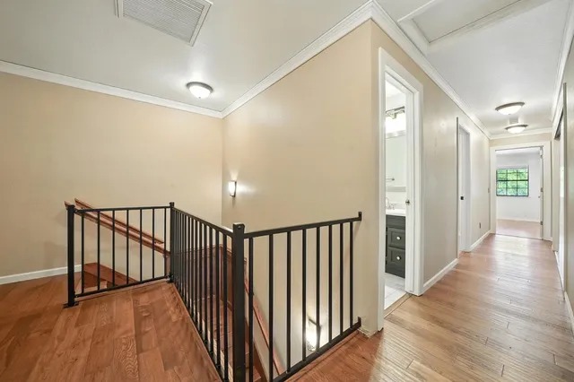 a view of an empty room with wooden floor