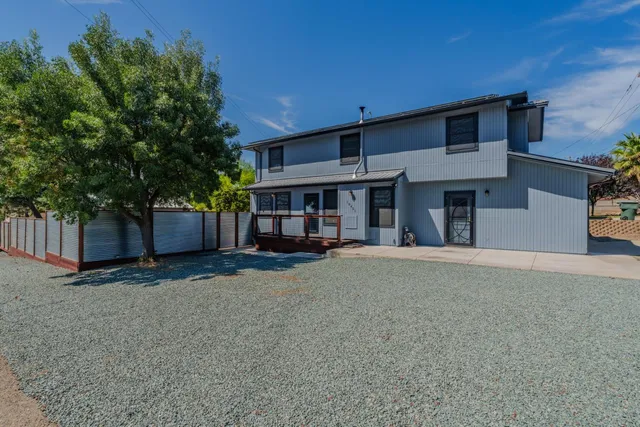 a view of a backyard with a tree