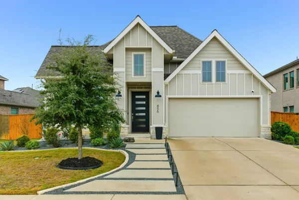 a front view of a house with yard