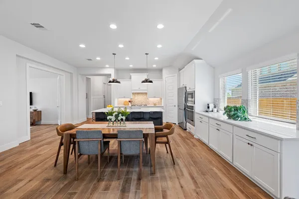 a view of a dining room with furniture and wooden floor