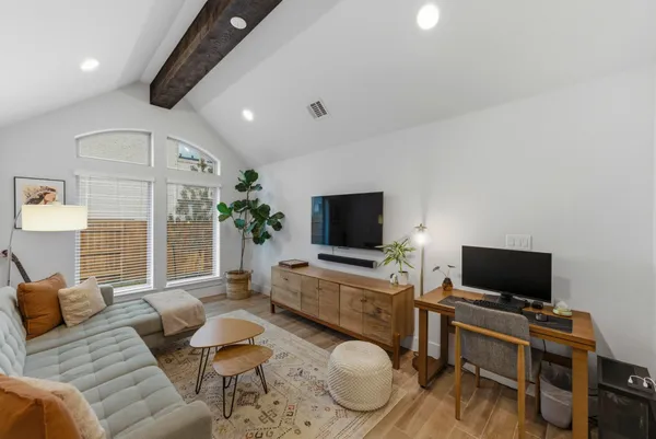 a living room with furniture and a potted plant