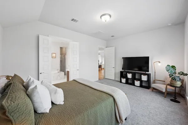 a spacious bedroom with a bed and a couch