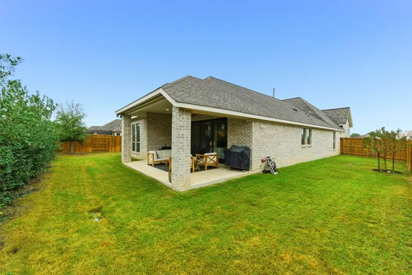 a swimming pool with outdoor seating and yard